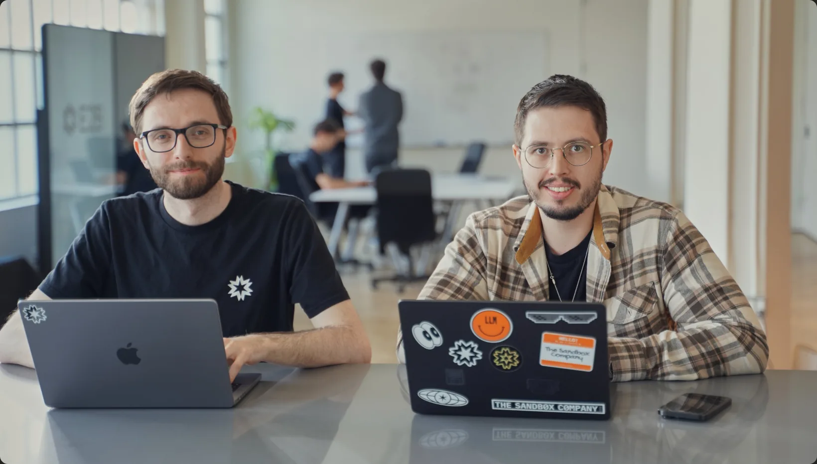 Two E2B engineers working together on laptops in the office